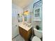 Bright bathroom with a single sink vanity, decorative mirror, and cabinet space for storage at 7329 Restful Springs Ct, Las Vegas, NV 89128