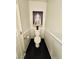 Small bathroom featuring toilet with Buddha wall art and dark flooring at 7329 Restful Springs Ct, Las Vegas, NV 89128