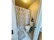 Cozy bathroom featuring a toilet and a shower with a modern geometric pattern curtain at 7329 Restful Springs Ct, Las Vegas, NV 89128