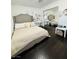 Bedroom featuring sleek floors, a sliding mirror closet and a grey upholstered bed at 7329 Restful Springs Ct, Las Vegas, NV 89128