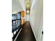 Bright hallway with unique lighting fixtures, hardwood floors, and accent wall art at 7329 Restful Springs Ct, Las Vegas, NV 89128