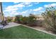 Spacious backyard with artificial turf, paver patio, and a shaded seating area at 788 Flowing Meadow Dr, Henderson, NV 89014