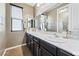 Double vanity bathroom with a large mirror and granite countertop at 788 Flowing Meadow Dr, Henderson, NV 89014