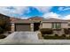 Single-story home with two-car garage and landscaping at 788 Flowing Meadow Dr, Henderson, NV 89014