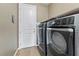 Convenient laundry room with washer, dryer, and built-in shelving at 788 Flowing Meadow Dr, Henderson, NV 89014