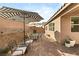 Patio with striped umbrella, table, chairs, and house view at 8113 Brown Clay Ave, Las Vegas, NV 89113