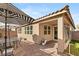 Outdoor patio area with seating, umbrella, and adjacent house at 8113 Brown Clay Ave, Las Vegas, NV 89113