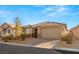 Single story home with a two-car garage and landscaped front yard at 8113 Brown Clay Ave, Las Vegas, NV 89113