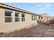 Tan house exterior with multiple windows and backyard patio at 8113 Brown Clay Ave, Las Vegas, NV 89113