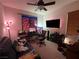 A bedroom with carpeted floors, a ceiling fan, and a window providing natural light at 8396 Waylon Ave, Las Vegas, NV 89178