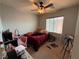 Cozy bedroom with carpet flooring and a ceiling fan that provides both light and air circulation at 8396 Waylon Ave, Las Vegas, NV 89178