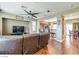 Inviting living room with hardwood floors, ceiling fan, and an open layout with views of the kitchen and dining area at 8396 Waylon Ave, Las Vegas, NV 89178