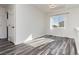 Bright bedroom with wood-look floors and window at 8428 Summers Ranch Ct, Las Vegas, NV 89139