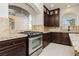 Kitchen features granite countertops, dark wood cabinets, and a stainless steel range at 8428 Summers Ranch Ct, Las Vegas, NV 89139