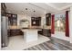 Modern kitchen with granite island, dark wood cabinets, and stainless steel appliances at 8428 Summers Ranch Ct, Las Vegas, NV 89139