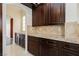 Additional kitchen counter space with granite top and wood cabinets at 8428 Summers Ranch Ct, Las Vegas, NV 89139