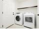 Laundry room with washer, dryer, and shelving at 8428 Summers Ranch Ct, Las Vegas, NV 89139