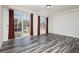 Living room with wood-look floors and sliding glass doors at 8428 Summers Ranch Ct, Las Vegas, NV 89139