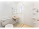 Bathroom with shower, toilet, and pedestal sink at 845 Palo Verde Dr, Henderson, NV 89015