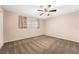 Cozy bedroom with carpet, window, and ceiling fan at 845 Palo Verde Dr, Henderson, NV 89015