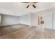 Open living room with neutral carpeting and a view to the kitchen at 845 Palo Verde Dr, Henderson, NV 89015