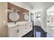 Bathroom with double vanity and modern wood-paneled feature wall at 8509 Copper Falls Ave, Las Vegas, NV 89129