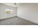 Bright bedroom with arched window and carpet flooring at 8509 Copper Falls Ave, Las Vegas, NV 89129