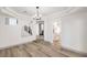 Bright dining room with hardwood floors and a chandelier, view to kitchen and staircase at 8509 Copper Falls Ave, Las Vegas, NV 89129