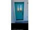 Teal front door with glass panels adds a pop of color to the home's exterior at 8509 Copper Falls Ave, Las Vegas, NV 89129