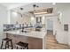 Modern kitchen with white cabinets, quartz countertops, and a wood accent wall at 8509 Copper Falls Ave, Las Vegas, NV 89129