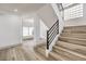 Modern staircase with metal railing and light wood steps at 8509 Copper Falls Ave, Las Vegas, NV 89129