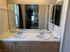 Bathroom with double sinks and large mirror at 8800 Roping Rodeo Ave # 103, Las Vegas, NV 89178