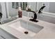 Modern bathroom sink features a gray granite countertop, stylish black faucet, and decorative soap dispenser at 889 Ariel Heights Ave, Las Vegas, NV 89138