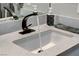 Close-up of a white bathroom sink with a unique faucet and decorative accents adding elegance at 889 Ariel Heights Ave, Las Vegas, NV 89138