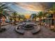 Beautiful sunset view of the vibrant community center with palm trees and modern architecture at 889 Ariel Heights Ave, Las Vegas, NV 89138