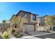 Attractive two-story house featuring a stone veneer, a paved driveway, and manicured landscaping at 889 Ariel Heights Ave, Las Vegas, NV 89138