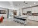 Bright kitchen with white cabinetry, stainless steel appliances, and an island with barstools at 889 Ariel Heights Ave, Las Vegas, NV 89138