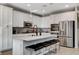 Kitchen featuring white cabinets, stainless steel appliances, and an island with seating at 889 Ariel Heights Ave, Las Vegas, NV 89138