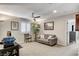 Upstairs living room with large windows providing plenty of natural light and cozy seating at 889 Ariel Heights Ave, Las Vegas, NV 89138