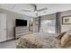 Serene main bedroom with a ceiling fan, soft lighting, and a large window that lets in plenty of natural light at 889 Ariel Heights Ave, Las Vegas, NV 89138