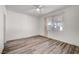 Bright bedroom with wood-look floors and ceiling fan at 9008 Rusty Rifle Ave, Las Vegas, NV 89143