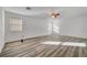 Large bedroom with wood-look floors and ceiling fan at 9008 Rusty Rifle Ave, Las Vegas, NV 89143