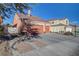 Two-car garage with driveway and landscaping; view of a house's exterior at 9008 Rusty Rifle Ave, Las Vegas, NV 89143