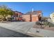 House exterior with two-car garage, landscaping, and a paved driveway at 9008 Rusty Rifle Ave, Las Vegas, NV 89143