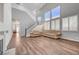 Living room with hardwood floors, fireplace, and high ceilings; view of staircase at 9008 Rusty Rifle Ave, Las Vegas, NV 89143