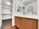 Bathroom with wood vanity, large mirror and closet at 9609 Rolling Thunder Ave, Las Vegas, NV 89148