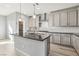 Kitchen island with black granite countertops, and stainless steel fixtures at 11579 Salt Creek Ave, Las Vegas, NV 89138