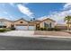 Single-story house with two-car garage, landscaping, and blue shutters at 2297 Aria Dr, Henderson, NV 89052