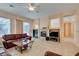 Spacious living room with fireplace, leather furniture, and TV at 2297 Aria Dr, Henderson, NV 89052