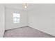 Spacious bedroom with grey carpet, window, and ceiling fan at 2932 Torreon Ln, Las Vegas, NV 89121